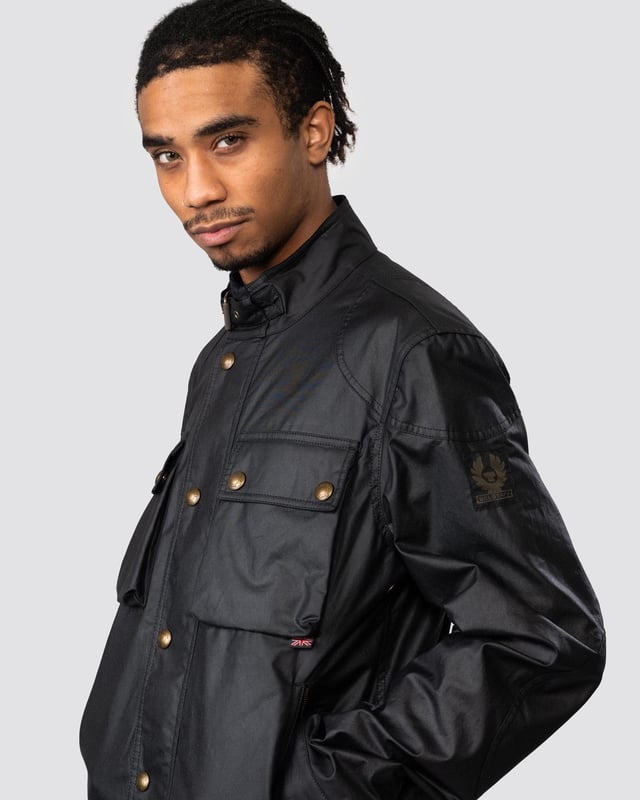 The Racemaster jacket in Faded Olive. There’s more to the Racemaster than meets the eye. Introduced back in 1981, it was originally billed as a shorter version of the iconic Trialmaster. This means that, along with the history, heritage, and dark navy 6 oz. waxed cotton, you also get increased mobility and freedom to move.

6 oz. waxed cotton, with a unique blend of micro and technical waxes
Four external pocket field jacket with reinforcement patches and corduroy details
Water-repellent and wind-repellent
Corduroy linings at the collar, cuffs and hem providing added comfort and resilience at high contact points
Signature antique brass metal hardware with Belstaff England engraved on the round and signature phoenix woven patch on left sleeve
Centre front zip closure with snap closure placket
Buckle-adjusted collar
Two press-stud flap pockets
Two lower zipped pockets
Left internal pocket

Shell: 100% Cotton, Body Lining: 100% CottonSleeve Lining: 55% Polyester, 45% Viscose/Rayon105306