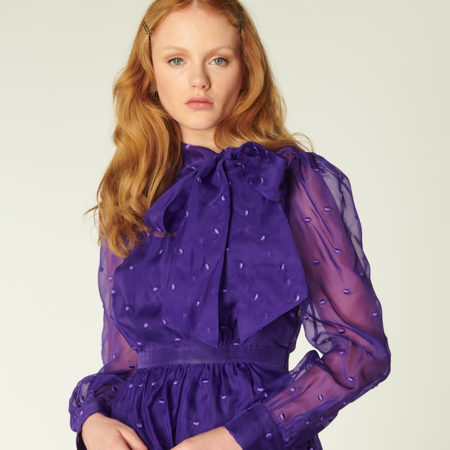 A vibrant play on our vintage-inspired Glinda pieces, Depp takes on the spotty organza in striking violet. Crafted from fine silk organza in purple dotted with purple embroidered spots, this long-sleeve dress has a round neck finished with an oversized bow, a slip layer, a nipped waist and a full skirt. Wear it with sharp courts and a clutch when those dressing up moments call.
