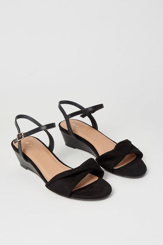 Wide fit design offers a comfortable and accommodating fit
Soft twist detailing adds an elegant touch to the upper
Low wedge heel provides a subtle lift while ensuring all-day wearability
Ankle strap with buckle closure ensures a secure and adjustable fit
Open-toe silhouette allows for breathability during warmer months

Exuding sophistication and versatility, these sandals from Wallis are the perfect choice for formal occasions. The wide fit design ensures a comfortable and accommodating fit, while the soft twist detailing adds an elegant touch to the upper. The low wedge heel provides a subtle lift while ensuring all-day wearability, making them ideal for events like weddings, races, or graduations. Style them with a tailored dress or a chic jumpsuit for a polished and refined look that radiates confidence and grace.