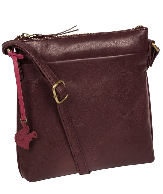 The 'Nikita' cross body bag from Conkca London is handcrafted from natural leather for a classic yet contemporary finish - perfect for elevating any look. With two full-length slip pockets on the exterior of the bag which arte perfect for on-the-go storage, complemented by a 100% cotton lining for a flawless finish. Comes with an adjustable leather strap and is adorned with the unimitable Conkca London squirrel logo and charm.