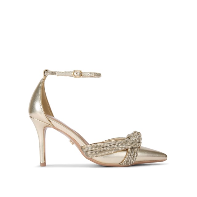 This Carvela Arielle Court heel features a gold upper with large crystal knot strap across the pointed toe. The ankle strap is also embellished with gold crystals. Heel height: 8cm.