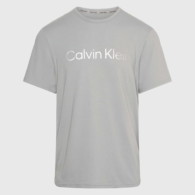 Mens Calvin Klein Lounge T- Shirt in grey.- Round neck.- Short sleeves.- Signature tape inside the neckline.- Logo print.- Regular fit.- Ref: 000NM2264E5JX