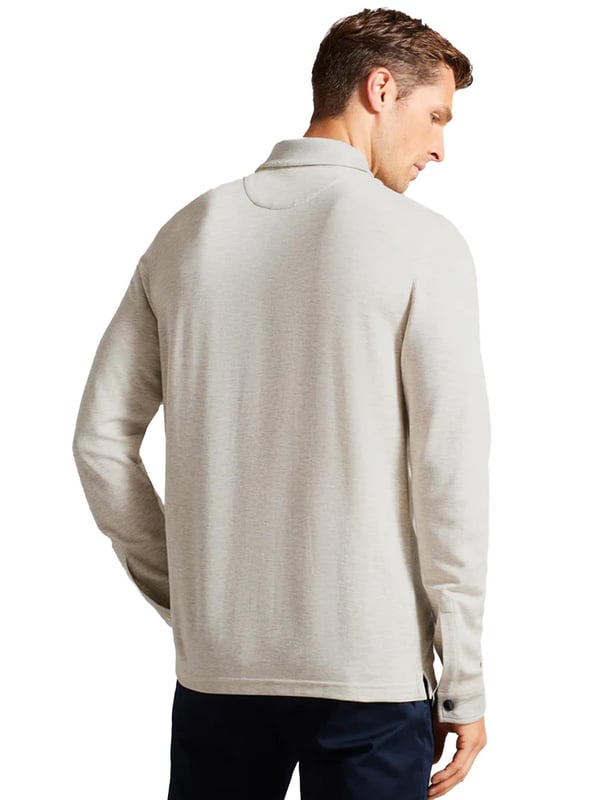 The Ted Baker men's Karpol long sleeve polo shirt in navy offers a refined take on a wardrobe staple. Crafted from a soft modal blend fabric, this polo delivers exceptional comfort and a luxurious feel against the skin. It features a classic collar and a zip placket, adding a modern twist to the timeless design. The long sleeves make it a versatile piece, suitable for both casual and smart-casual looks, providing style and ease for any occasion.
