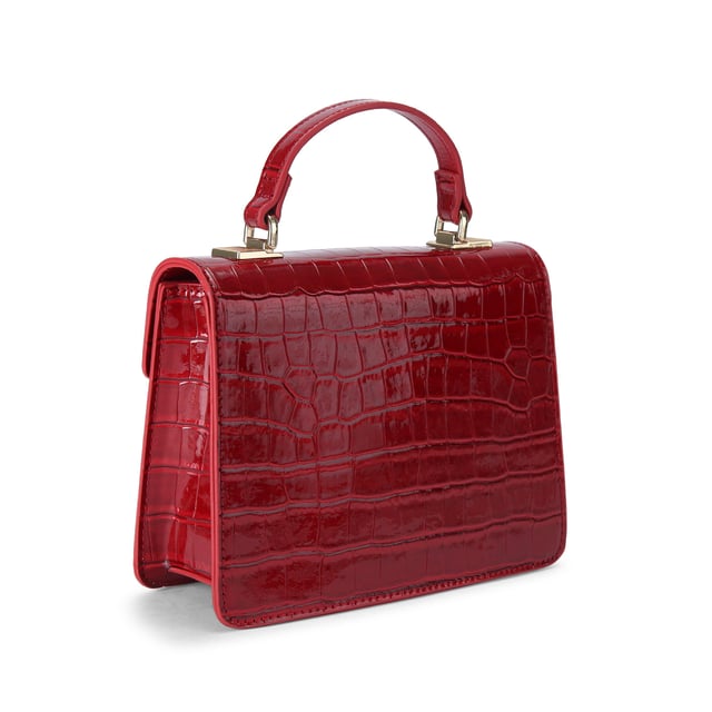 This Carvela Jessica Top Handle Bag features a deep red exterior with large croc print. There is a gold branded plate on the front flap. Dimensions: 15cm (H), 17cm (L), 7cm (D). Strap length: 125cm.