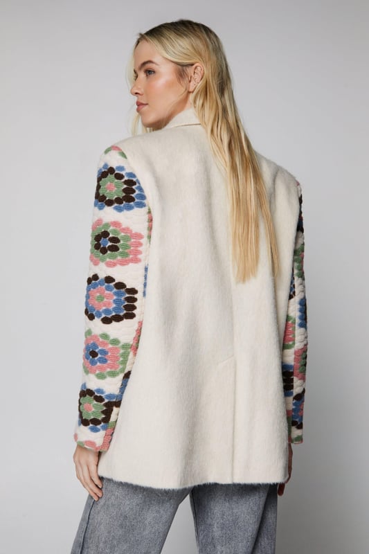 Layer up. Feel protected from the elements in our coat, in a cozy wool blend fabric, with crochet detailing. Pairs well with a casual fit for an elevated daytime look, or wear it over a mini dress for a levelled up night out look. Premium Wool Blend Crochet Blazer Coat High Quality Wool Blend Fabric Unique Crochet Style Details Comfortable Relaxed Fit Button Fastenings in Front Pocket Accents Model wears a size M (US size 6/UK size 10).