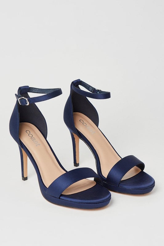 Elegant faux leather heeled sandals with a platform sole
Ankle strap with metallic buckle fastening for a secure fit
Open toe design to elongate the leg
Towering stiletto heel height of 7-9cm
Metallic finish exudes sophistication and glamour

Crafted with meticulous attention to detail, these Talia Platform Heeled Sandals from Coast are the epitome of refined elegance. Designed to make a statement at formal occasions like weddings, races, or graduations, these sandals radiate luxury. Style them with a floor-length gown or a tailored midi dress for a polished and sophisticated look that commands attention. Embrace the allure of these sandals and let them be the centerpiece of your ensemble, elevating your confidence and poise for an unforgettable evening.