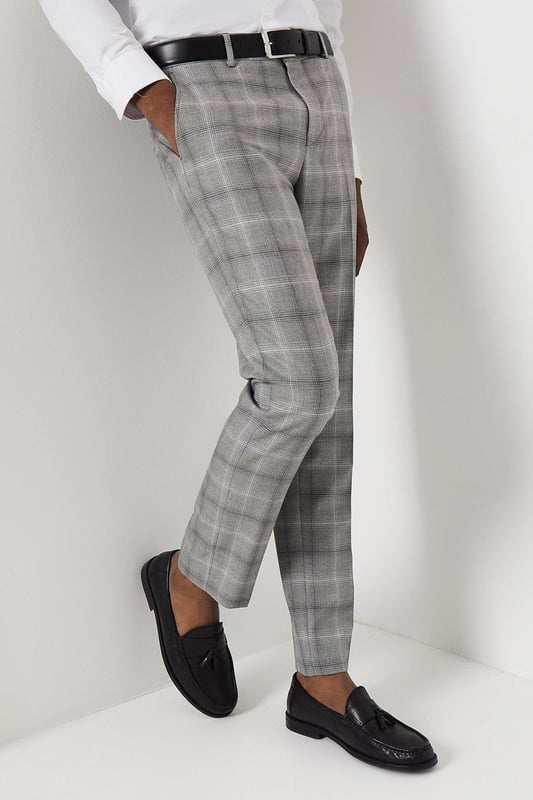 Slim fit tailored trousers with a sleek, tapered silhouette
Crafted from a fine grey check patterned fabric
Flat front styling with slant side pockets
Belt loops to accommodate a smart leather belt
Hem designed to sit neatly on the shoe

Exuding refined sophistication, these slim fit trousers from Burton are the epitome of smart tailoring. Pair them with a crisp shirt and blazer for a polished look at formal occasions or dress them down with a knitted jumper for elevated weekend styling. The slim cut flatters the frame while the grey check pattern adds a touch of classic British flair, making them a versatile choice for the modern gentleman's wardrobe.