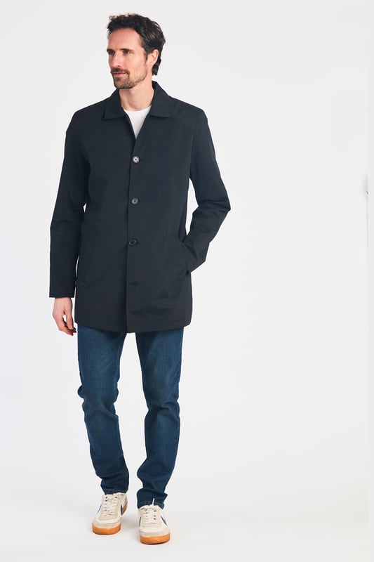 This men's mac-style coat from Kensington Eastside features a classic collar, button-up fastening, and a mid-length cut for a sleek, modern look. Lightweight and stylish, it’s perfect for layering over both casual and formal outfits, making it a versatile wardrobe essential for effortless style.