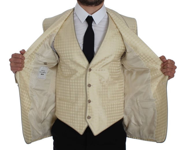 Brand: Dolce & Gabbana
  Style: 2 Piece Single breasted two button blazer and vest
  Fitting: Slim fit
  Color: Beige and gold
  Three outside pockets and two inside pockets
  One open vent in the back
  4 button closure vest with adjustable back strap
  Logo details
  Made in Italy
  Material: 58% Polyester 42% Silk
  Lining: 51% Acetate 49% Rayon
Material: 58% Polyester 42% Silk