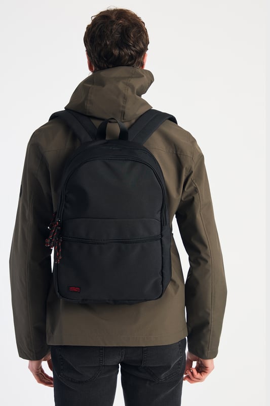 Black Multi Compartment Backpack This basic black backpack from Tokyo Laundry features striking red detailing on the zip and a signature Tokyo Laundry badge. Perfect for everyday use, it combines style and practicality with spacious compartments and durable design. A sleek, functional accessory for carrying your essentials in style.
