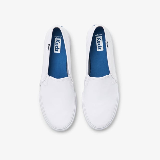 A slip-on sneaker with a major following. The bestselling Double Decker is a crowd favourite for a number of reasons: it’s super flattering on the foot (much more so than other sneaker brands’ slip-on), it has cushiony wear-all-day-every-day insoles, and it’s an effortless outfit maker.

Features:

Imported
Feminine last
Canvas upper
Rubber outsole
Cushioned footbed
Slip-on style sneaker

Care Instructions: spot wash, air dry only

Box Contains: Keds Double Decker White Slip-on Sneakers for Women