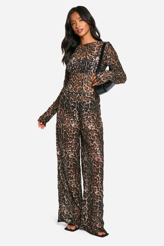 Alluring lace fabric with eye-catching leopard print
        Flattering crop length for a trendy silhouette
        Slim fit design accentuates curves
        Long sleeves for versatile styling options
        Round neckline adds a touch of sophistication
    
    Make a bold statement with this captivating petite crop top from Boohoo. The alluring lace fabric adorned with a striking leopard print pattern creates a head-turning look that's perfect for the fashion-forward woman. The slim fit and crop length work together to showcase your figure, while the long sleeves offer versatility for various occasions. Style this top with high-waisted black trousers and strappy heels for a night out with friends, or pair it with your favourite denim and trainers for a more casual daytime ensemble. The round neckline adds a touch of elegance, making this piece suitable for family gatherings or casual events. Embrace your wild side and let this lace crop top be the centrepiece of your outfit, reflecting your confident and trendy personality.