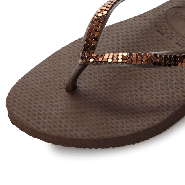 Add some sparkle to your summer style with this metallic mesh flip flop. A classic toe post style with slim straps and miniature branded coin charm.
