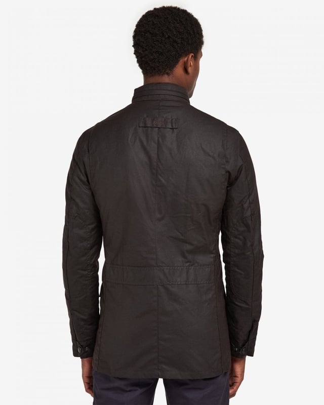 Barbour Corbridge Wax Jacket
The Corbridge is a rugged utility-style men's waxed jacket updated with a contemporary engineered fit. With winter in mind, this multi-functional jacket is constructed in Barbour's hardy 6oz Sylkoil waxed cotton with a comfortable, lightweight Nylon lining quilted to 50g wadding, for additional warmth. The corduroy-lined funnel collar features an integral Nylon hood complete with adjustable toggles for a perfect fit, offering wet-weather defence when needed but easily stowed away in the collar on dry days. Built to offer comfort and protection to those who are active outdoors in any weather, the Corbridge benefits from adjustable cuffs, a robust two-way zip, a storm fly front with stud fastenings and an action back. The classic four-pocket detail adds a stylish, practical feature that keeps essentials safe and hands free. Available in a choice of three versatile colours. As this is a slim fitting jacket, we would advise purchasing the next size up than you would normally choose.

Tailored Fit
Barbour tonal embroidery to left pocket
Outer: 100% cotton (waxed)
Inner: 100% polyamide
6oz waxed cotton
Do not wash
Sponge clean only
Back length: 78.8cm - 83cm

MWX0340
