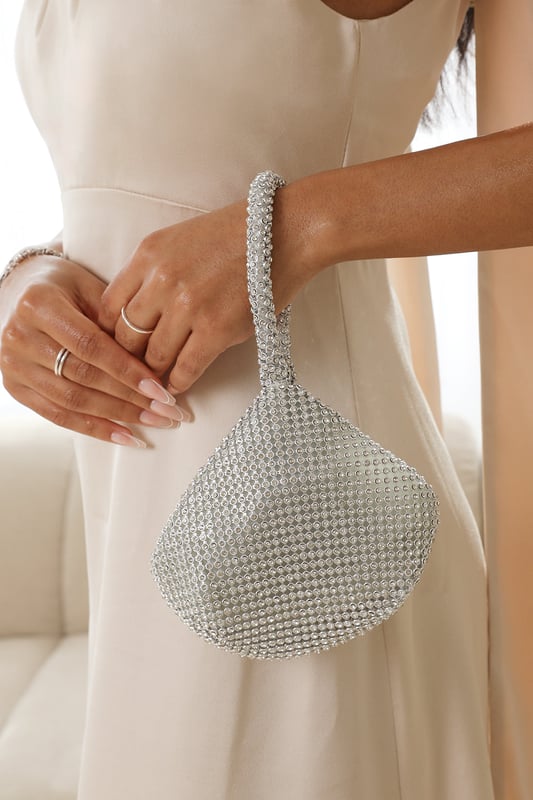 Get ready to dazzle and shine with our Rosa mini chainmail pouch bag. This exquisite bag combines elegance with a touch of glamour, perfect for making a statement at any special occasion.Key Features:



Dazzling Design: The mini chainmail construction of this pouch bag is adorned with shimmering diamante crystals. The intricate pattern and sparkling embellishments create a mesmerizing effect that will capture everyone's attention.

Compact and Portable: This mini pouch bag is designed to hold your essentials while keeping you stylishly organized. It comfortably fits your phone, keys, lipstick, and other small items, making it perfect for a night out or a special event.

Secure Closure: The pouch bag features a secure zippered closure to keep your belongings safe and secure throughout the day or evening. You can enjoy your event without any worries about accidental openings.

Premium Quality: Crafted with attention to detail and using high-quality materials, this bag is built to last. The sturdy construction ensures durability and longevity, allowing you to enjoy the bag for many occasions to come.


Specifications:


Material: Chainmail with diamante crystals
Closure: Zippered closure

Add a touch of glamour and sophistication to your ensemble with our Rosa mini chainmail pouch bag. Its dazzling design and versatile styling options make it the perfect accessory to elevate your look and express your unique sense of style. Get ready to sparkle and shine with this stunning bag.