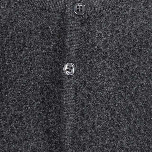Tricot knit jacket.
 Closed round neck.
 Button closure on the front.
 Plate with the name of the brand on the lower side.
 Composition: 75% Cotton, 20% Polyamide, 5% Wool
 Care:
- Wash maximum at 30ºC.
 - Iron at medium temperature, max. 110ºC.
 - It is not allowed to use a dryer.
 - Do not use bleach.
 - Does not support dry cleaning.