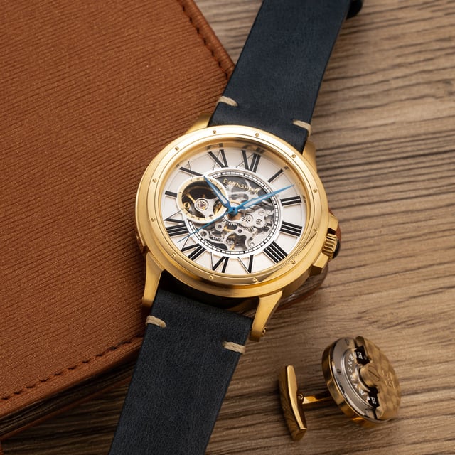 Collection: Comet Open Heart Skeleton 
Model: Es-8243-03
Movement: Automatic 
Case Material: Stainless Steel
Case Diameter (mm): 42
Case Thickness (mm): 14
Case Shape: Round
Case Color: Gold
Dial Color: Silver
Band: Genuine Leather Strap
Band Color: Blue
Buckle: Strap Buckle
Band Width (mm): 22
Water Resistance: 5 Atm
Watch Weight (g): 140
Warranty: 2 Years International Warranty