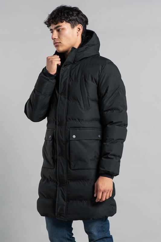 This longline funnel neck hooded padded jacket from Nines by Kensington Eastside will ensure you are kept warm on colder days. Features funnel neck, hood, zip and popper fastening, two large popper fastening pockets and two zip chest pockets, ribbed elasticated cuffs for comfort, and inside fur lining in half the jacket.