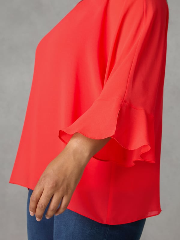 In striking red, this top has a super soft, stretchy jersey vest-style underlayer for that all-important coverage, and an elegant, floaty chiffon overlayer that moves beautifully. With bracelet-length, fluted sleeves and a lengthening V-neck, it has a swingy A-line shape thats designed to flatter. Dress this up or down, depending on your plans.