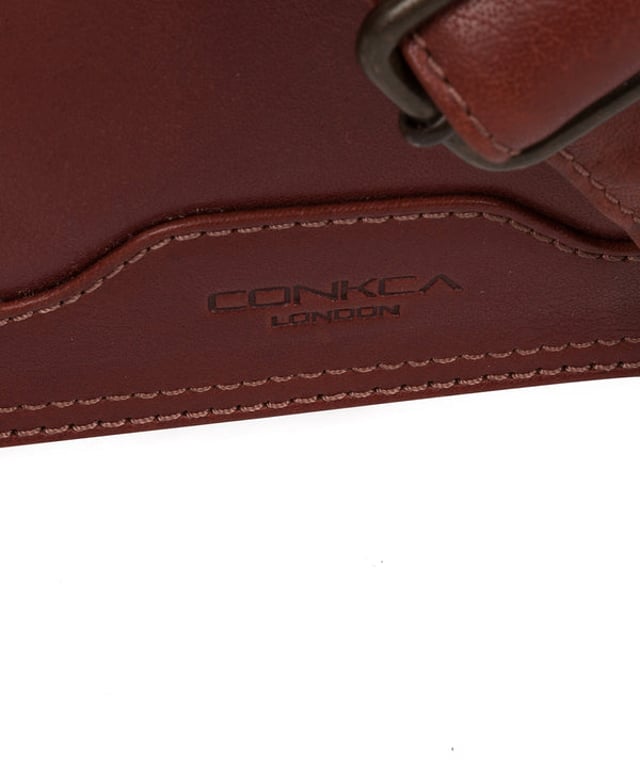 Handcrafted from full-grain natural leather, the 'Zico' messenger bag from Conkca London comes with a robust finish. The handsome accessory features a fold-over top secures a spacious central compartment which is lined with natural, untreated 100% cotton lining alongside rustic metal fittings and zips. Ample storage space is provided by a padded laptop pocket on the interior. Comes with an adjustable strap with a maximum drop length of 70cm and adorned with the handsome Conkca leather label.