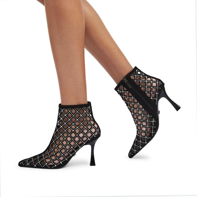 This Carvela Ankle Boot features a black microsuede upper with cut out details and silver crystals across the upper. The toe is pointed with an interior smoked lining and the heel is flared in design. Heel height: 8.5cm.