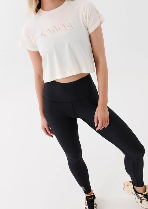 Slightly relaxed fit tee in a cropped length. Fine ribbed neckline. KAAIAA flat rubber logo and P.E Nation flat rubber logo on sleeve