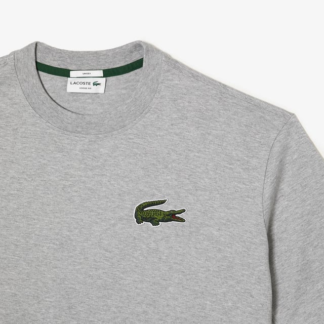Finest materials. Brand’s singular expertise. The perfect expression of Lacoste’s timeless wardrobe -Loose fit is loose ease on body and sleeves  lower shoulders and armholes -Unisexe T-shirt in organic heavy jersey with big croc 80' on chest -7cm iconic original badge crocodile at chest -3cm green crocodile at under middle back collar