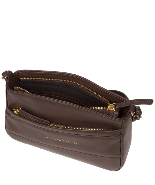 The 'Helena' cross body bag from the Pure Luxuries Marylebone collection is handcrafted from high-quality, genuine Nappa leather with a natural super-soft touch. The zip-over top opens to reveal a 100% cotton-lined interior. The spacious compartment features two slip pockets to help maintain an organised bag. A zipped pocket on the front of the bag provides on-the-go storage. Features gold-coloured metal fittings and zips alongside the adjustable slim leather strap, with a maximum drop length of 65cm. The Pure Luxuries logo is embossed in gold foil for a beautifully simple finishing touch.