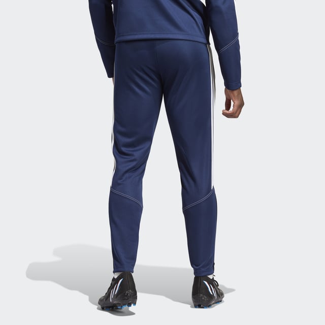Essential training gear from adidas. Before you hit the pitch for that chilly winter session, layer up in these Tiro 23 Club football pants. Their slim, streamlined fit and moisture-absorbing AEROREADY will keep you flying through sprints and rondos. Once you reach perfect temperature, ankle zips make pulling them off over your boots a breeze.Made with 100% recycled materials, this product represents just one of adidas' solutions to help end plastic waste.  - Slim fit with mid rise - Elastic waist with drawcord - 100% polyester (recycled) - AEROREADY - Side zip pockets - Ankle zips  Shipped by adidas