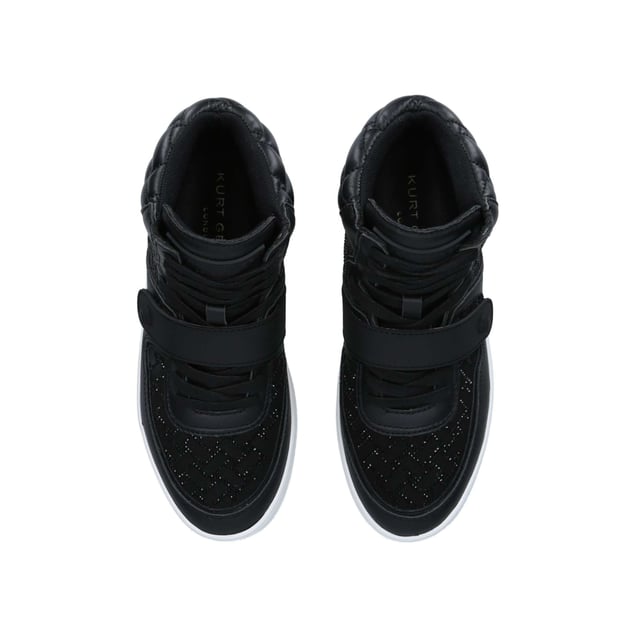 The Kurt Geiger Legacy Crystal sneakers feature a quilting design made with black crystals. The front is lace up with rubber strap going across the foot topped with mini black Eagle head. The ankle is softly padded with overstitch quilting.