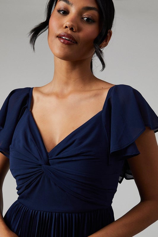 Ethereal crinkle chiffon fabric for a romantic look
        Sweetheart neckline with elegant twist detail
        Graceful angel sleeves add a whimsical touch
        Floor-length maxi silhouette for a sophisticated appearance
        Pleated skirt creates beautiful movement and texture
    
    This enchanting bridesmaids maxi dress from Coast is the epitome of grace and elegance. Perfect for your role in the bridal party, the crinkle chiffon fabric drapes beautifully, creating a soft and romantic silhouette. The sweetheart neckline with its delicate twist detail draws attention to the dcolletage, while the angel sleeves add a touch of whimsy and femininity. The pleated skirt flows gracefully to the floor, ensuring a stunning entrance as you walk down the aisle. Pair with delicate drop earrings and a simple bracelet to complete your bridesmaid ensemble. This dress is designed to complement the bride while allowing you to shine in your supporting role on this special day.