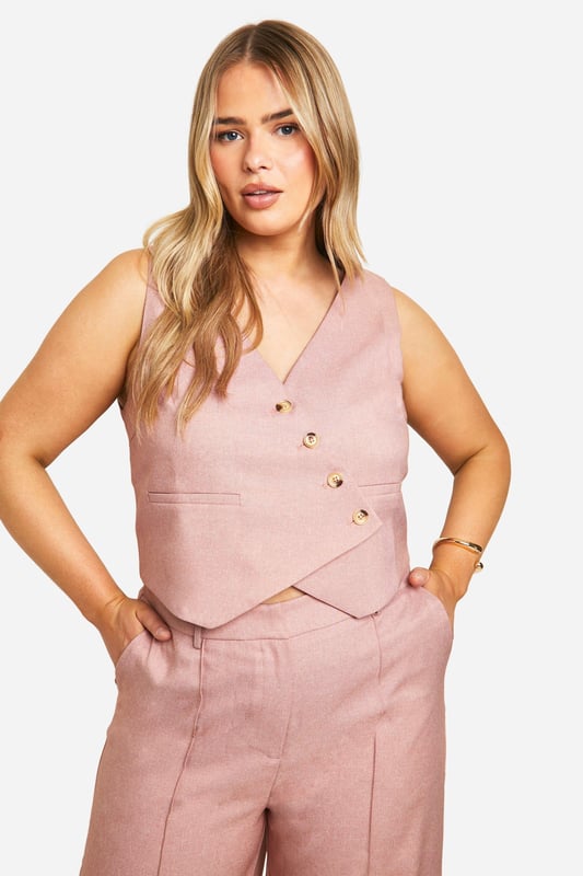 Plus Asymmetric Marl Waistcoat Add the finishing touch to your outfit with this outerwear piece from our women's plus size coats range. A wardrobe staple that's perfect for layering, this style provides added warmth and adds an extra something to your fit. Made with added fabric for the perfect fit, this piece is a whole vibe - just throw on over your fave outfit and you're sorted. Whether you choose a plus size denim jacket or keep things cosy in winter with a plus size teddy coat we've got the hottest coats for curvy girls that are always on-trend. Style: WaistcoatFabric: WovenNeckline: AsymmetricSleeve Length: Sleeveless