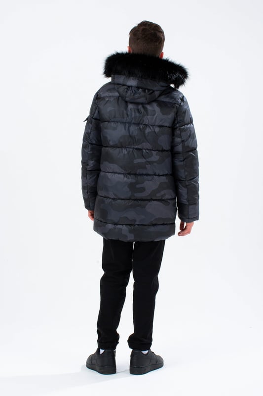 Imagine a completely versatile jacket that features both the parka and puffer style. Meet the HYPE. Kids Camo Explorer Jacket, part of the HYPE. 2022 Back to School collection. Designed in our standard unisex explorer parker shape, in our signature camo print in khaki and brown. Finished with an arm pocket and embossed justhype logo zip puller and a faux fur brown neutral hood trim. Machine wash at 30 degrees to keep in new condition.