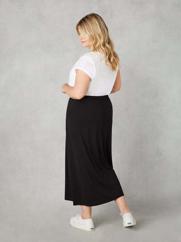 The perfect throw-on piece, this black jersey midi skirt is as flattering as it is comfortable. In a super soft, stretchy jersey, its designed to skim your curves beautifully, and has an elasticated back waistband for the perfect fit. Pair with anything from a T-shirt to a jumper for effortless daytime cool.