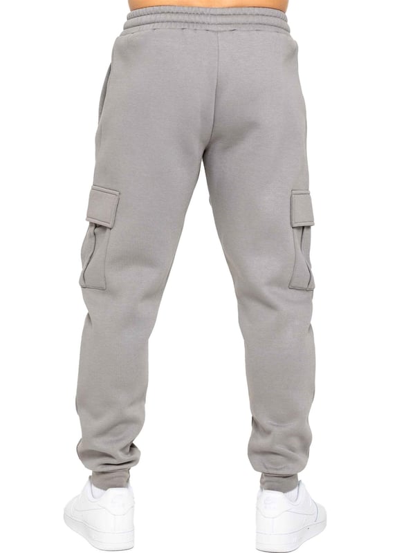 Experience superior comfort and style with Enzo Men's Regular Fit Cargo Joggers! Crafted with a brushed back inner fleece lining, these joggers are designed to keep you cozy all day long. Perfect for casual wear, they feature convenient 2 side slash pockets and 2 cargo pockets, providing ample storage space for your essentials. Stay on-trend with the cuffed leg design, offering a modern silhouette and added comfort.