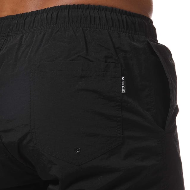 Mens NICCE Plinth Swim Shorts in black.- Elasticated drawstring waist.- Two open front pockets. - Single back pocket.- Mesh inner briefs.- Logo to leg.- Flat hem.- Regular fit.- Shell: 100% Nylon. Lining: 100% Polyester.- Ref: 1059W0050001