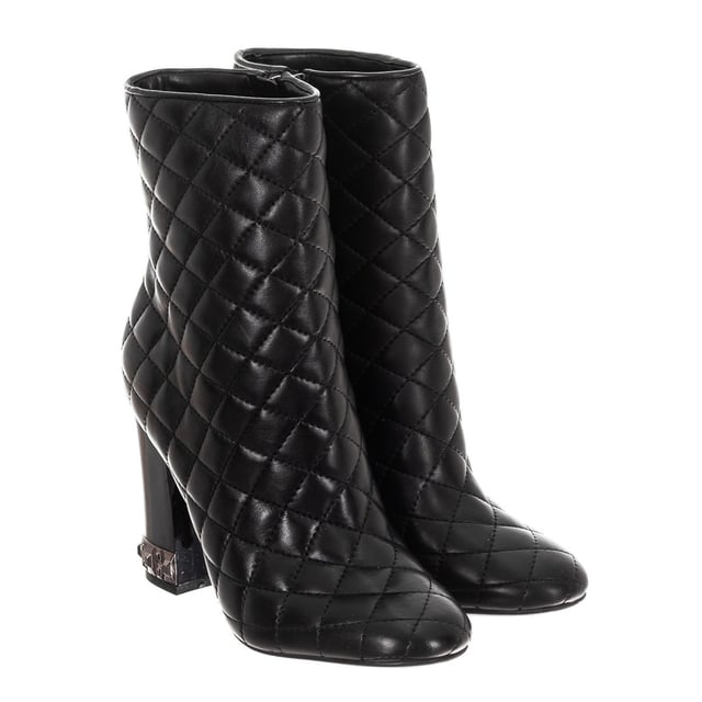 Boots with original design.
 Round toe.
 Quilted finish.
 Metal application of the brand on the back
 Template customized by the brand.
 Rubber sole with non-slip grooves.
 Metallic detail on heel.
 Seams seen in tone.
 Measures: Heel: 10cm
 Composition: Exterior: Leather; Interior: Leather; Sole: Synthetic
 Care:
Hand wash with a damp cloth.