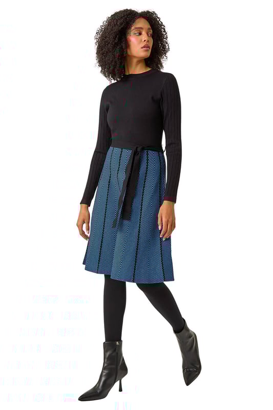 Chevron Print Belted Jumper Dress from Roman. Upgrade your daytime wardrobe with this elegant knee-length, knitted dress. Cut from a soft knitted fabric this dress features a modest round neckline and cosy full-length sleeves. A printed, panelled contrast skirt falls to a fun knee-length in a flattering fit and flare style. A self-tie fabric belt adds shape at the waist if desired while its pull-on style makes for quick and easy dressing. Pair with tights, boots and a fluffy gilet for a cute and casual everyday style!