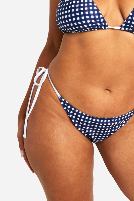 Sky high condfidence is inevitable in this plus size swimwear  from our latest collection. Curve enhancing, silhouette smoothing, and perfect for poolside lounging, this style is guaranteed to make you feel like the best version of yourself. Pair with a floaty kimono and some oversized sunnies and prepare to cause a storm. Need more inspo? Choose a plus size swimsuit for sunset loving nights at the beach or a plus size bikini to snatch that tan. Available in a range of prints, colours, and silhouettes, from high waisted to one pieces, grab yourself some dreamy curve swimwear that makes you feel confidently you.shop it all on boohoo.Style: Bikini BottomsDesign: GinghamFabric: Polyester