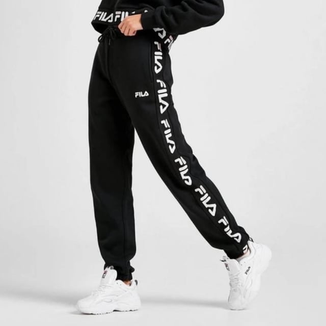 Fila Womens Jacquard Panel Joggers in a Black. 
These Soft Pants have a Luxe Feel to Them While Offering Ultra Comfort. 
These Joggers Have Elasticated Cuffs with Waistband for a Perfect Fit. 
Finished With a White and Black Fila Taping Down Both Legs and a Fila Logo to the Thigh. 
80% Cotton, 20% Polyester. 
Machine Washable.