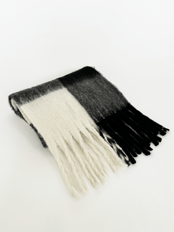 Stay warm and stylish this winter with the Chunky Black and White Check Scarf Bag Everyday Essential Bundle by SVNX. This statement accessory features a bold black and white check pattern with a cozy, chunky knit. Perfect for adding a touch of modern style and warmth to your winter outfits, this scarf effortlessly combines fashion and function. A matching bag to go with the Scarf making your outfits even easier. Perfect for gifting or getting yourself a matching set. Bag Colour: Black. Material: 100% Polyester. Bag Size: W - 45cm H - 35cm. Bag Care: Wipe Clean Only. Bag SKU: HB326202. Unisex Chunky Scarf in Black and White Check. Scarf: One Size. 100% Polyester. Wash at 30. Scarf SKU: SC2303902. Bundle SKU: BD2400101