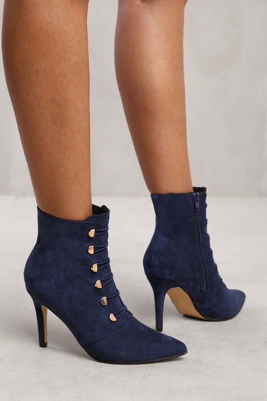 Step out in style with our Leane Pointed Toe Mid Heel Ankle Boots with Gold Buttons. These fashionable ankle boots are designed to add a touch of sophistication and flair to any outfit.Key Features:



Chic Design: The pointed toe and gold buttons on these ankle boots create a stylish and eye-catching look. These boots effortlessly elevate your style, making you stand out from the crowd.

Comfortable Fit: Despite their sleek design, these ankle boots prioritize your comfort. The mid heel provides a comfortable lift, while the pointed toe allows for a snug fit and adds a touch of elegance.

Durable Construction: Made with high-quality materials, our Pointed Toe Mid Heel Ankle Boots with Gold Buttons are built to last. The sturdy construction and reliable stitching ensure their durability, making them perfect for everyday wear.

Easy to Wear: These ankle boots feature a convenient side zipper closure, allowing for easy on and off. The gold buttons add an extra touch of luxury to the design.


Specifications:


Material: Faux Suede
Closure: Zip
Heel Height: 3.9 inches
Toe Shape: Pointed Toe

Invest in our Leane Pointed Toe Mid Heel Ankle Boots with Gold Buttons for a perfect combination of style, comfort, and sophistication. Make a statement and turn heads wherever you go. Get yours today and step into a world of fashionable elegance!