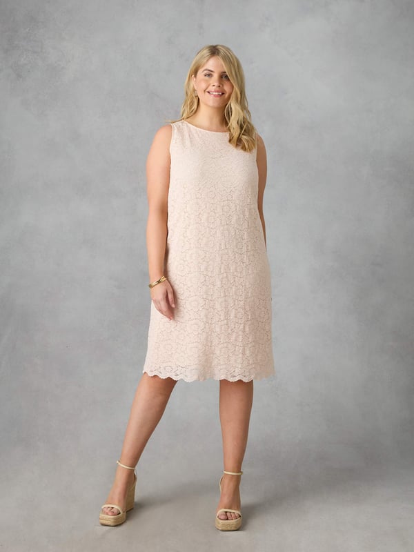 Cut from a beautiful lace in a sophisticated blush pink colour, this dress is fully lined with a breathable woven lining. It has a round neck and a flattering sleeveless, knee-length shape with a scalloped hem, making it the perfect wedding guest dress.