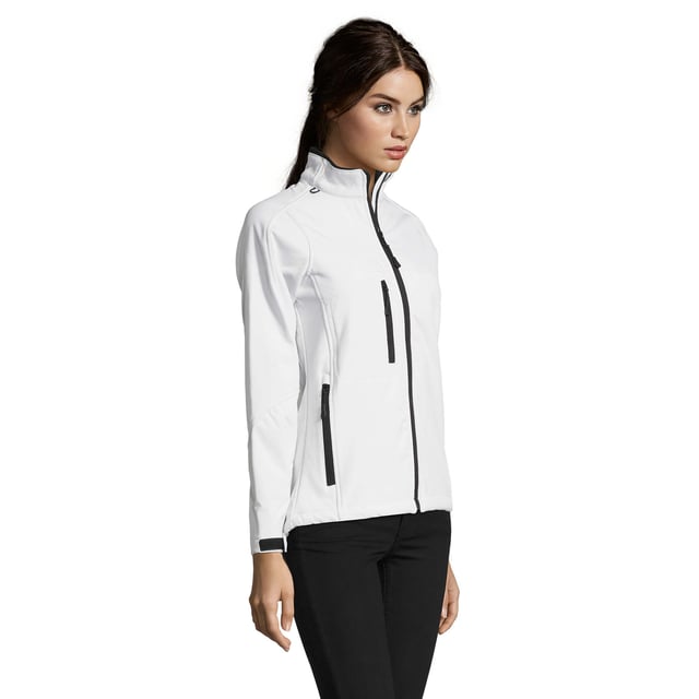 Stretch soft shell fabric has an elastane outer membrane with polyester fleece backing. Mesh lined front body panels. Breathable, windproof and water resistant. Shaped fit with taped neck. Collar high full zip with inner storm flap and chin guard. Two front zip pockets and one right chest zip pocket. Tear release adjustable cuffs. Adjustable drawcord at hem. Drop tail. Access for decoration. Material: 96% polyester/ 4% elastane outer. Ladies size: S(8/10), M(12), L(14), XL(16), XXL(18).