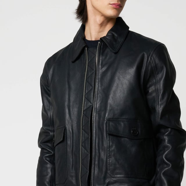 Men’s Barneys Originals goat leather bomber jacket. Features classic patch pockets, a Harrington-style collar, and knit rib detailing on the cuffs and hem for a timeless, structured fit.