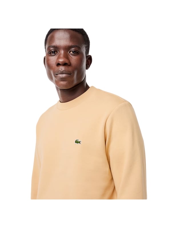 Timeless style renewed every season in a new color palette  in our signature details and a sustainable approach. Classic fit  natural ease on body with comfortable sleeves. Solid crewneck sweatshirt in brushed fleece made of organic cotton and recyled polyester. Piqué necktape in iconic Lacoste green. Embroidered 3cm green crocodile sewn on chest.