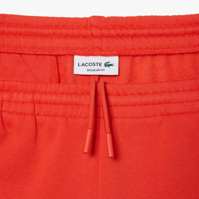 Men's Lacoste Organic Brushed Cotton Fleece Shorts Regular fit  straight cut: Unrestricted movement. Drawstring at waist: An adjustable waistband for optimal comfort. Piped back pocket: Practical and functional. Embroidered crocodile sewn onto front: Lacoste signature performance. Brushed organic cotton fleece: Long-lasting comfort during practice.