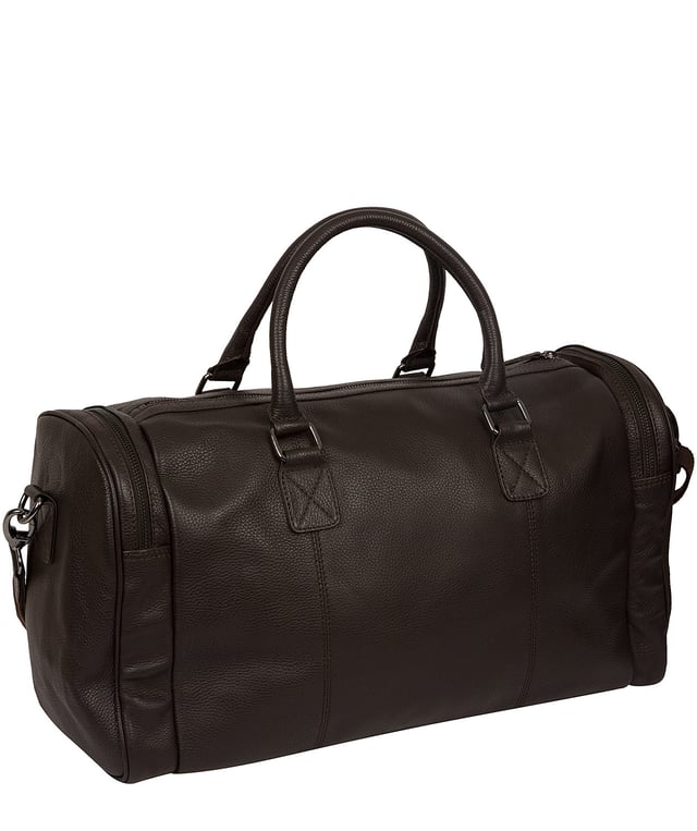 Crafted from natural leather with a supple and ultra-soft feel, the 'Ocean' holdall from Cultured London is the perfect bag for a when travel is on the agenda. The zip-over top secures the main compartment, concealing the 100% natural cotton lining. Two outer zipped pockets provide extra storage solutions, complemented by metal fittings. Comes with matching leather grab handles and an adjustable strap with a drop length of 70cm. Finished with the contemporary embossed Cultured London logo.