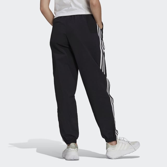 No reason is too small to treat yourself. In fact, you don't even need a reason. And with these adidas track pants in your closet, you can treat yourself any minute of the day. They're all about comfort, which is exactly what you'll feel when you slip them on. This product is made with Primegreen, a series of high-performance recycled materials.  - Regular fit - Drawcord on elastic waist - 100% recycled nylon plain weave - Side zip pockets - Elastic cuffs - Primegreen  Shipped by adidas