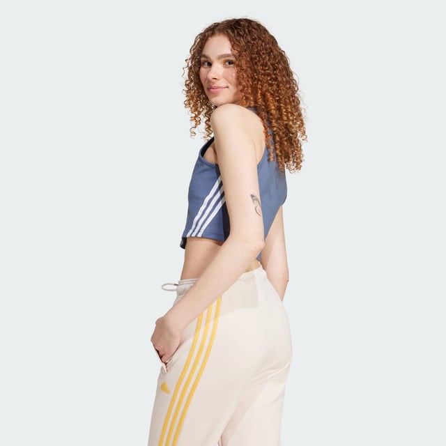 Embrace the future in this iconic design. This adidas tank top is great for both sport and leisure with its soft, stretchy fabric and distinctive 3-Stripes. Slip into this top and stay comfortable whether you're travelling or taking it easy. The cotton in this product has been sourced through Better Cotton. Better Cotton is sourced via a chain of custody model called mass balance. This means that Better Cotton is not physically traceable to end products.Find out more here: https://bettercotton.org/who-adidas-are/our-logo/  - Slim fit - Round neck - 90% cotton, 10% elastane - 3-Stripes wrapping tape - adidas Badge of Sport - Sourced through Better Cotton via a system of mass balance and therefore this product may not contain Better Cotton  Shipped by adidas